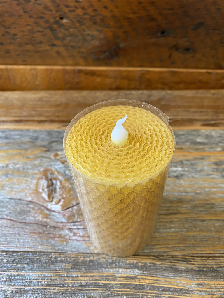 A shot showing the honeycomb candle top to show how this candle looks like rolled honeycomb..