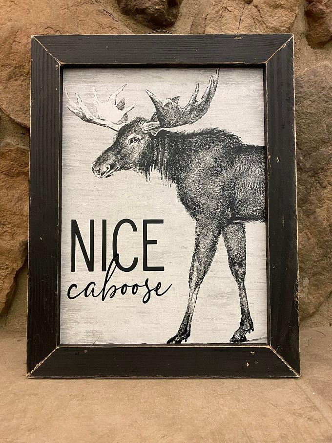 This fun picture has a moose and the words, "Nice Caboose". It is in a black wooden distrssed frame and measures 13" x 17". There is a vintage wire attached to the frame for easy hanging.