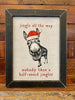 A black and white sign with a donkey wearing a red santa hat staring at you. The words are in red around the donkey say:  Jingle all the Way - no one likes a Half Assed Jingler. 