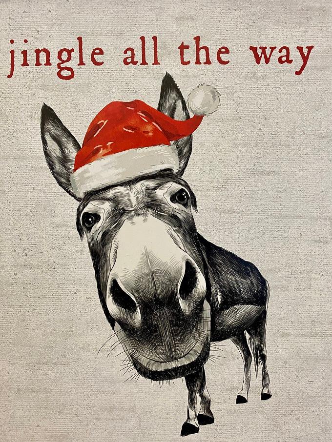 A black and white sign with a donkey wearing a red santa hat staring at you. The words are in red around the donkey say:  Jingle all the Way - no one likes a Half Assed Jingler.  This is close up of the donkey.