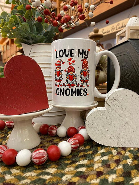 Love My Gnomes mug features three gnomes all holding hearts with red hats. 