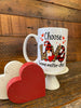 The Choose Love Gnome Mug has a gnome with a red and black hat and leopard print letters.