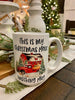 This is a white ceramic mug printed with the words "This is my Christmas movie watching mug" and a red barn, red truck and evergreen trees in a snowy holiday scene. 