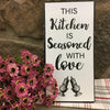 Seasoned with Love Kitchen Sign is a metal sign with black writing and image of salt and pepper shakers.