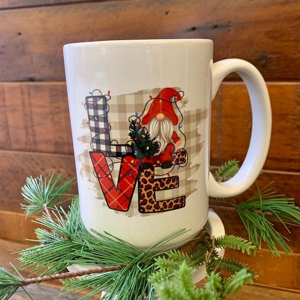 The word love is in capitals on the this LOVE Gnome Christmas mug. a picture of a gnome replaces the O in the words LOVE. 