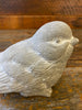 A side view of the grey resin bird showing details on the wings
