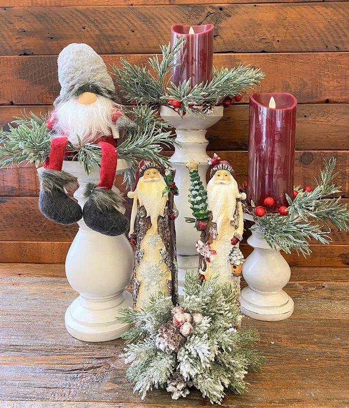   Distressed white wooden candle handles in three sizes are shown with farmhouse Christmas decor.