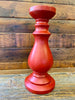 Tall red wooden candlestick. 