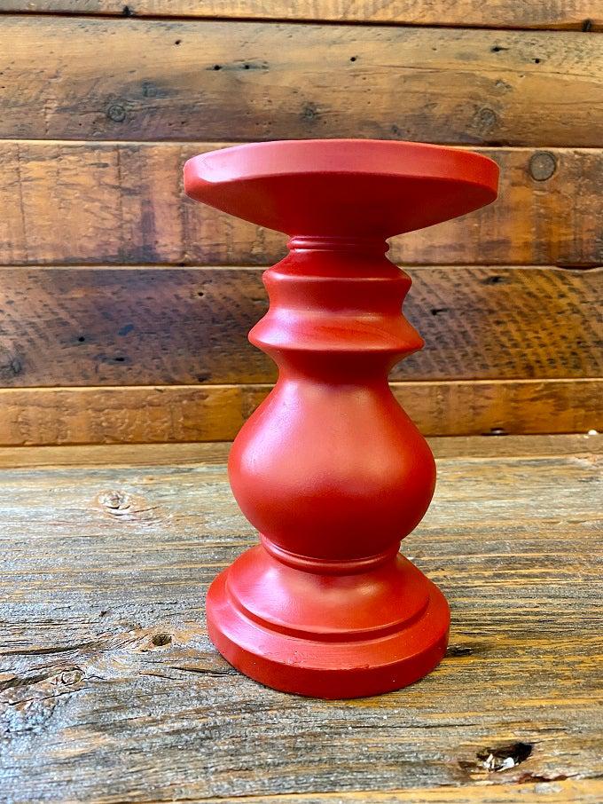 Small red wooden candlestick.
