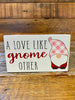 Wooden valentine gnome block sign that says A love like gnome other.
