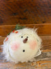 A close up of the face of the stuffed snowman.