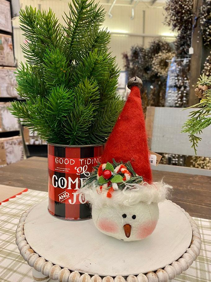 This little plush snowman has a tall red toque with a tiny jingle bell at the top. He has a round face, tiny carrot nose and painted face. 