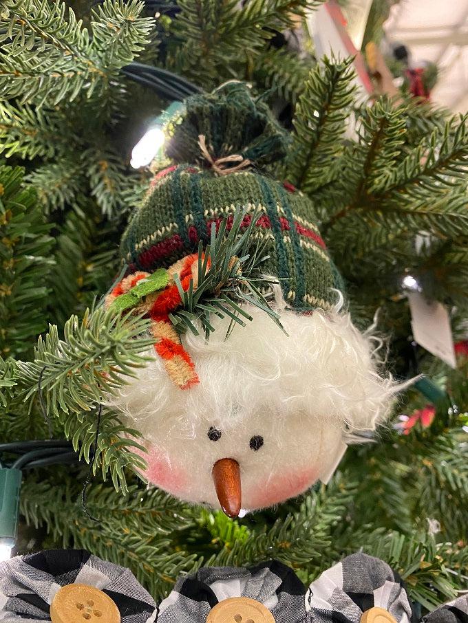 This little plush snowman has a green toque tied at the top. He has a round face, tiny carrot nose and painted face. 