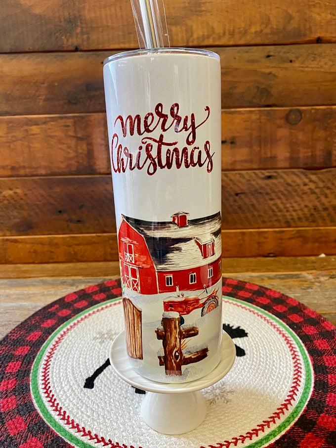 The Merry Christmas Red Barn Christmas Hot/Cold Tumbler bottle is wrapped in a pretty christmas  scene with a classic red barn and snow-filled evergreen trees. 
