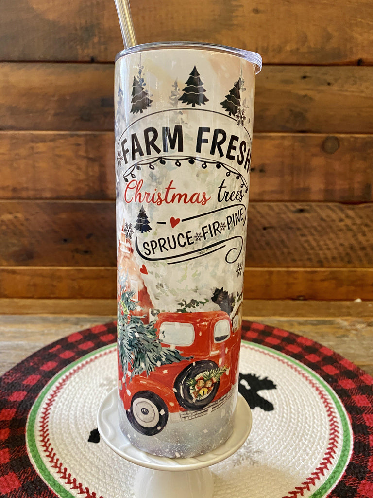 The Christmas Farm FreshHot/Cold Tumbler bottle is wrapped in a pretty christmas  scene with a vintage red truck and snow-filled evergreen trees. 