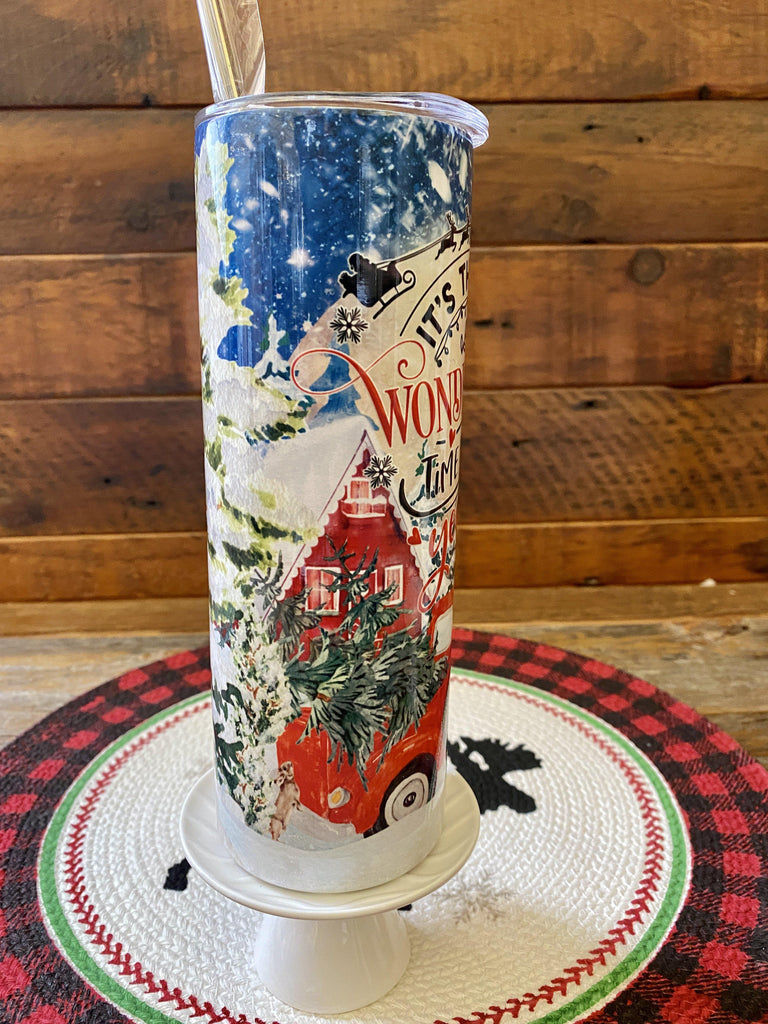 The Most Wonderful Time Hot/Cold Tumbler bottle is wrapped in a pretty christmas  scene with a vintage red truck and snow-filled evergreen trees. 