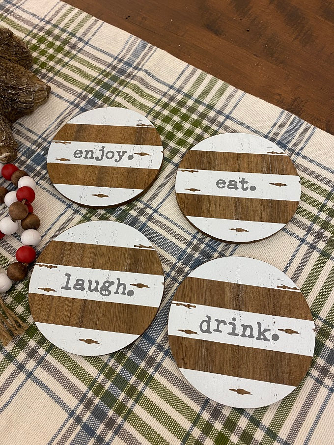 The Chippy Paint Wood Coaster  - Set of Four is shown. Each has a different word - enjoy, eat laugh and drink.