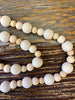 Cream wooded beaded garland available at quilted cabin home decor.
