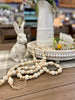 Cream wooded beaded garland available at quilted cabin home decor.