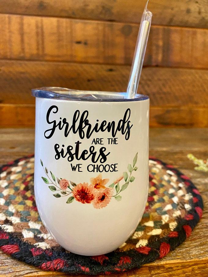 A white stainless steel wine tumbler with metal straw that says  Girlfriends are the sisters we choose. 