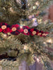 The fabric Yoyo garland is a pretty farmhouse garland. Red and Black fabric circles are drawn together to look like flowers and a button is sewn onto each flower of this 6 foot long garland.