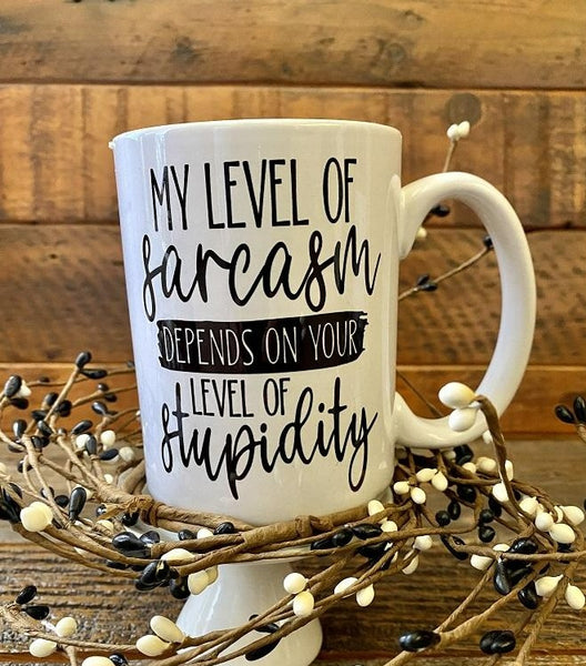 The sarcasm and Stupidity mug. A white ceramic mug that is printed on both sides and says My level of sarcasm depends on your level of stupidity.