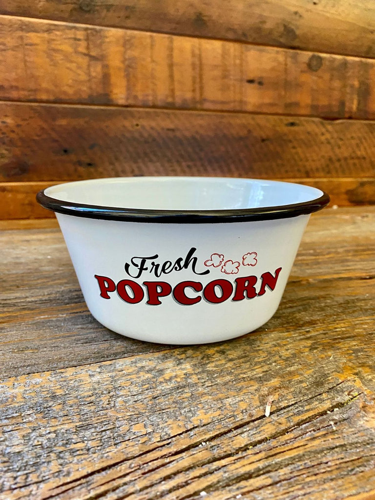 A white enamel bowl with a painted black rim has the words Fresh Popcorn on the side.