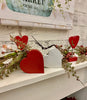The Distressed Hearts - Two Colours. One is white and one is red. Shown here on a fireplace mantle.