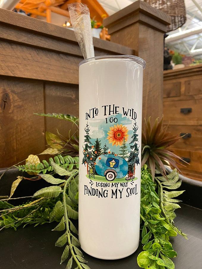 This is a white enamel coated stainless steel water, so it looks shiney! The water bottle comes with a reusable straw and is imprinted on both sides with a sentiment that says Into the wild I go, losing my way finding my soul. These words are around a camping scene picture of a blue camper, with a sunflower sun and pine trees.